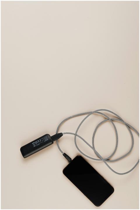 Overhead shot of a smartphone charging with a powe