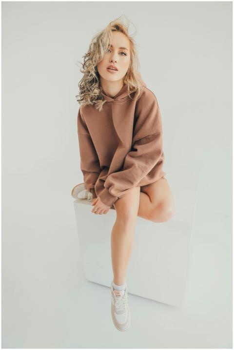 A young woman with long blonde hair poses in a cas