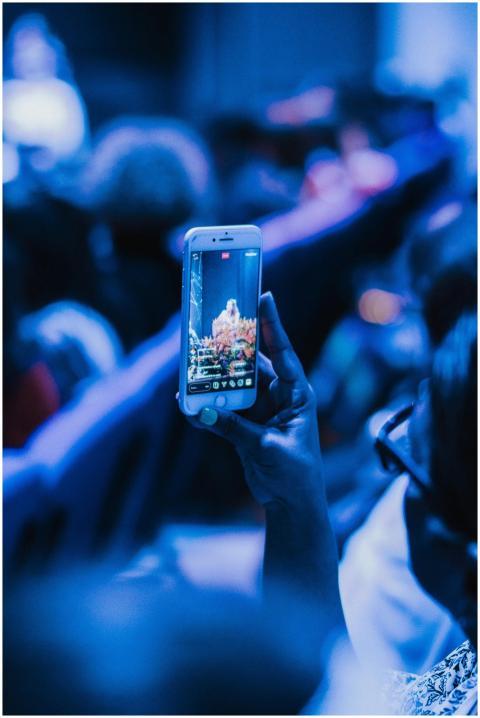 Close-up of a person recording a live performance