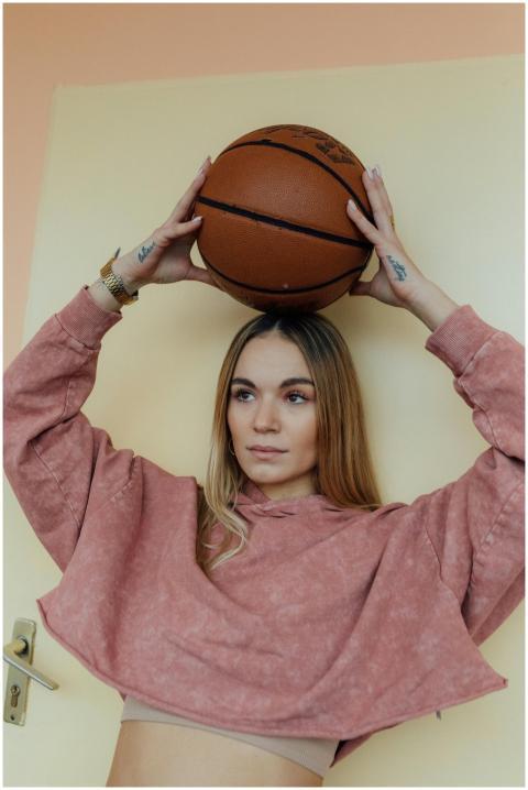 Portrait of a young woman with a basketball, embod