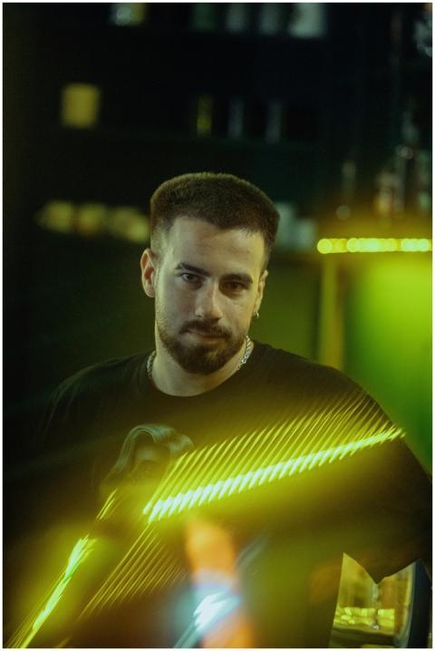 Artistic portrait of a DJ in a neon-lit environmen