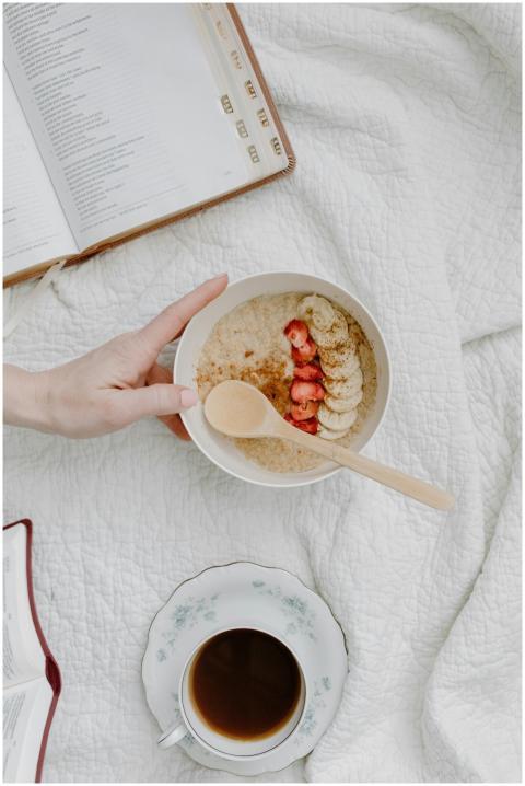 A cozy breakfast scene with a bowl of oatmeal, cof