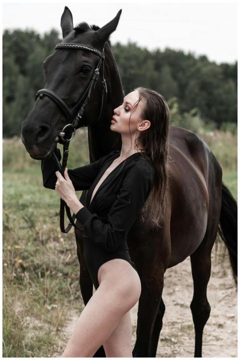 A fashionable woman in a bodysuit poses confidentl