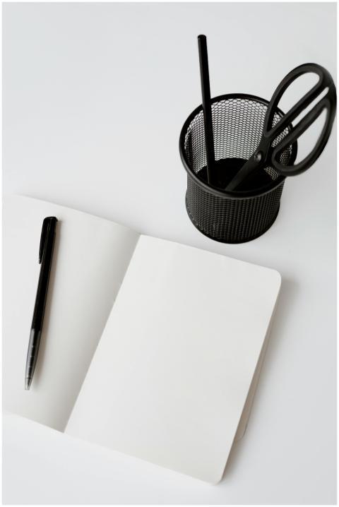 A minimalist workspace featuring an open notebook,
