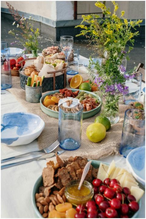 A beautifully set brunch table outdoors featuring