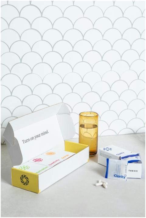 Box of nootropic supplements with pills and glass