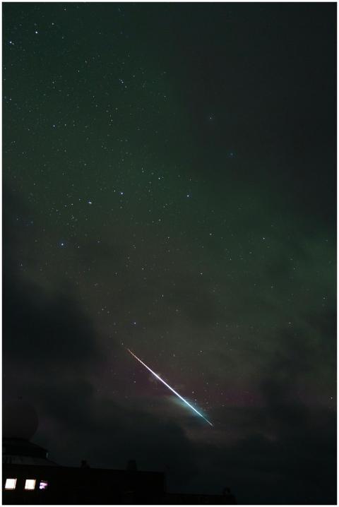 Captured meteor streak through a starry night sky