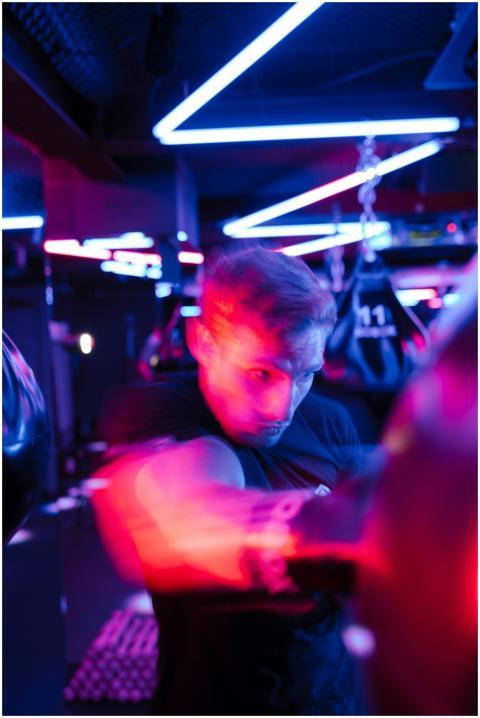 A determined boxer striking a punching bag under v