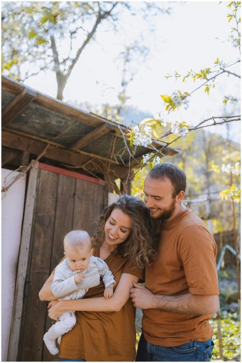 Smiling family with baby enjoying a sunny day outd