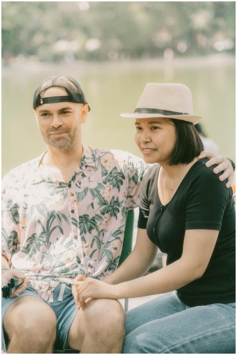 A couple sitting together by the lake, enjoying a