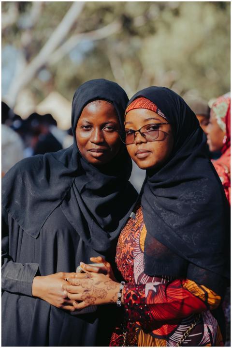 Two African women in vibrant traditional attire en