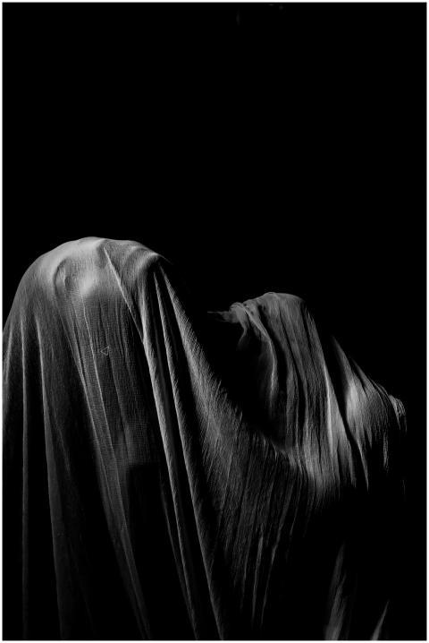 A captivating monochrome image of a draped figure
