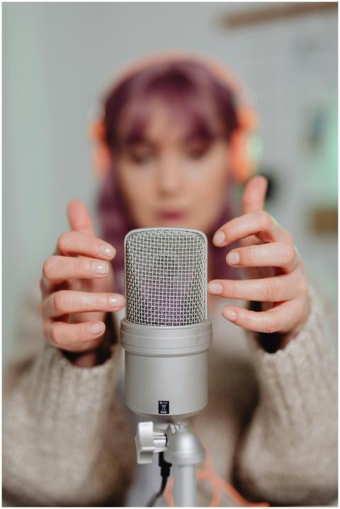 Close-up of a woman recording ASMR with a micropho