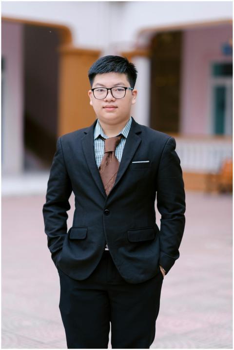 Confident young man in formal attire outdoors. Per