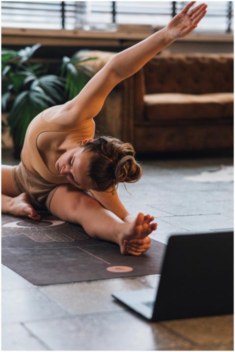 A woman engaged in a yoga session on a mat in a co