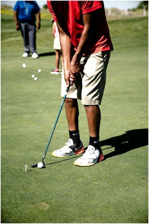 A golfer practicing a putt during a leisure game o