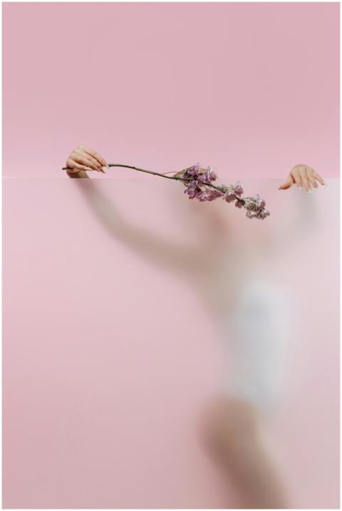 Blurred artistic silhouette of a woman with flower