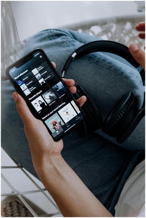 Close-up of a person holding a smartphone with hea