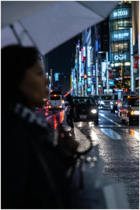 Rainy night scene capturing blurred pedestrian cro