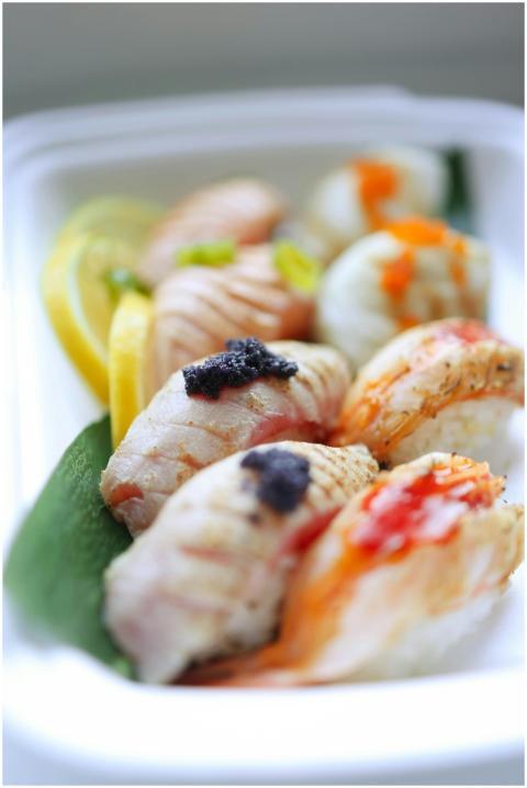 Close-up of a gourmet sushi platter with lemon sli