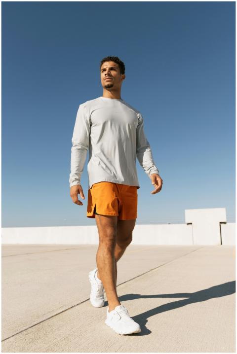 Athletic man walking on a rooftop in Austin, showc