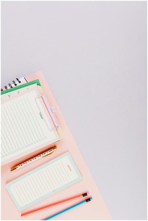 A top view of neatly arranged stationery items wit