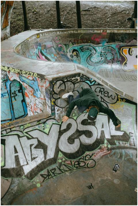 Skateboarder executing a wall ride in a colorful g