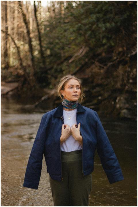 Woman in a casual outfit confidently posing by a f