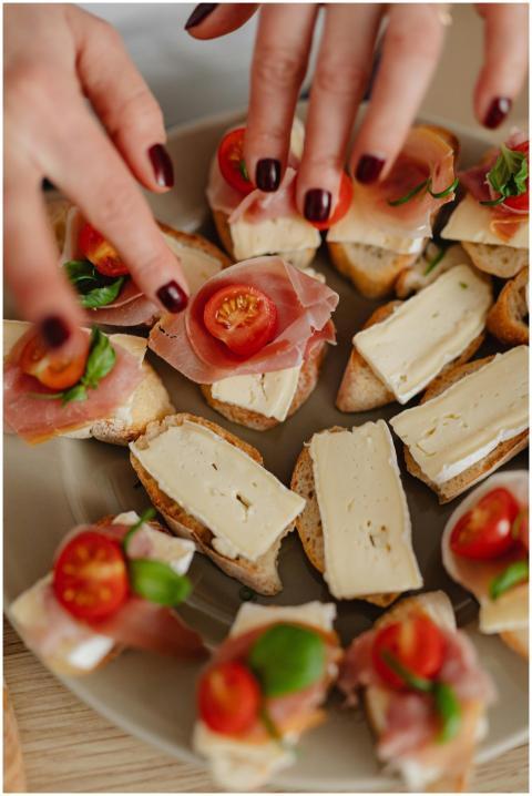 Close-up of hands preparing tasty bruschetta with