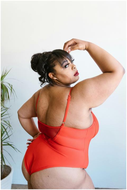 Empowering image of a plus-size woman in a red swi