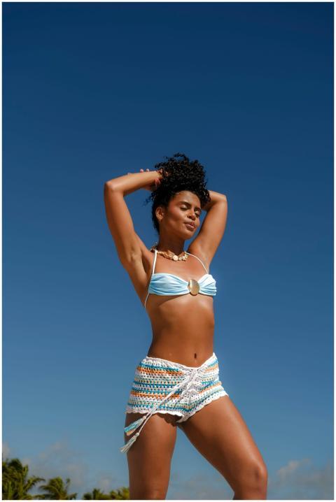 Woman in blue and white swimwear posing confidentl