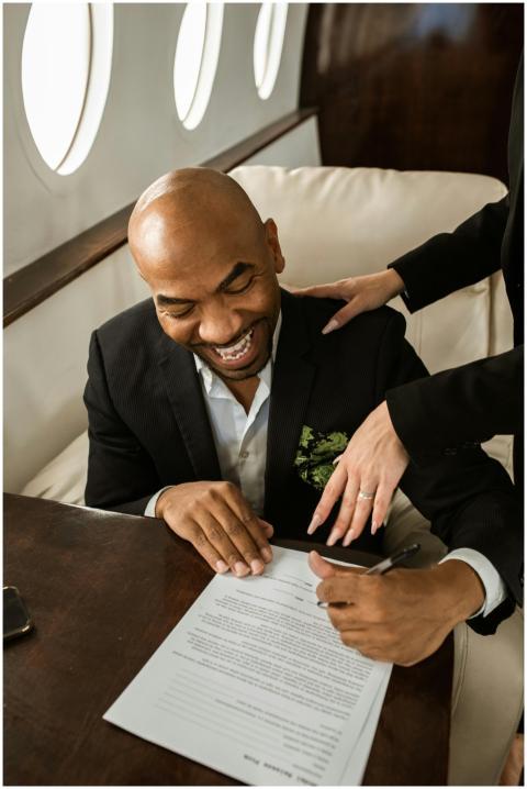 Businessman happily signing a document aboard a lu