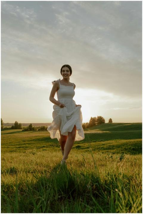 A woman joyfully runs through a sunny meadow, capt