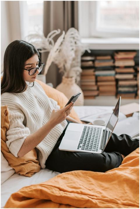 Side view of focused young female student sitting
