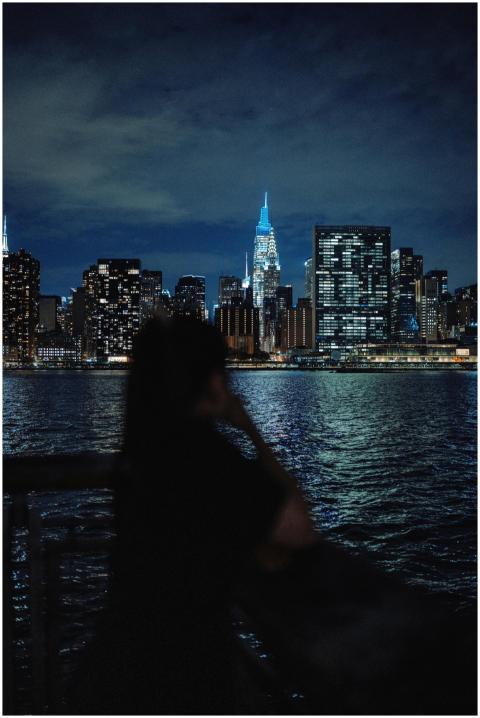 Silhouette of a person viewing the illuminated cit
