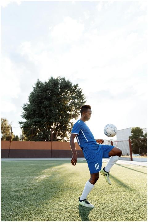 A young athlete practicing soccer skills on a sunn