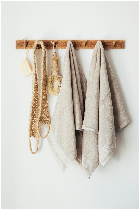 Minimalist bathroom decor with towels and eco-frie