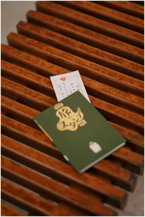 A Japanese travel document resting on a rustic woo