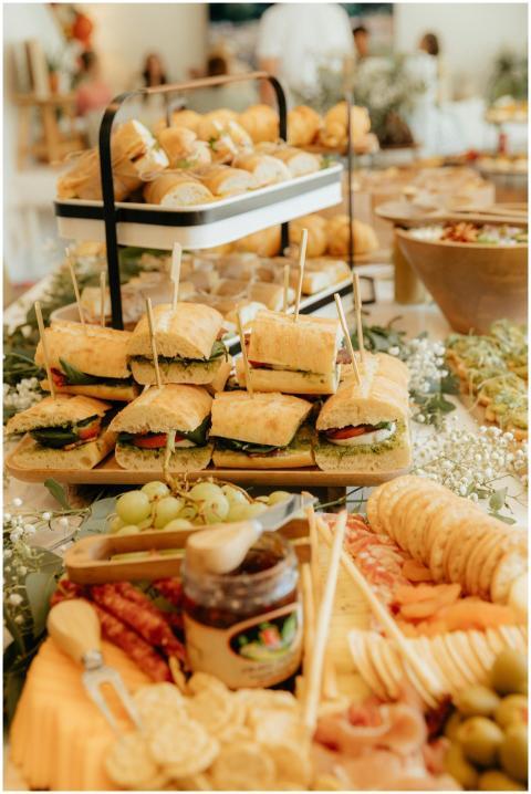 A vibrant buffet spread featuring sandwiches, crac
