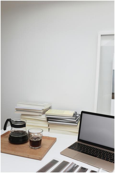 A modern workspace setup with a laptop, coffee pot