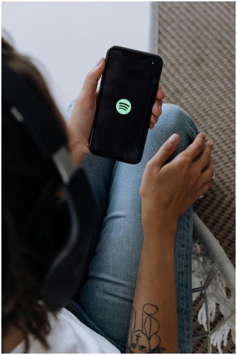 A person listening to music with headphones and sm