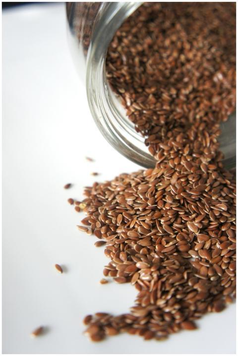 High angle view of flaxseeds spilling from a jar o