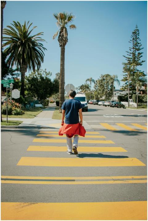Man crossing a sunny street in Coronado, Californi