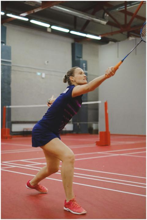 Woman in sports clothing playing badminton in indo