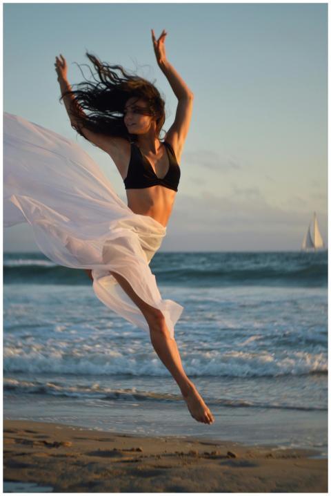 Full body of young focused ballerina in black bra