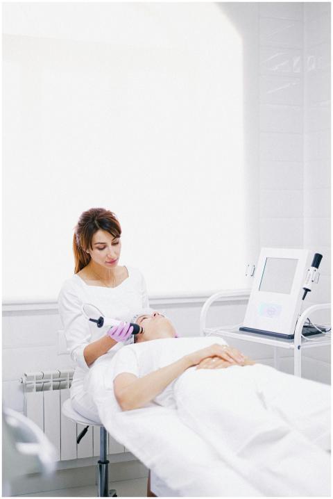 A beautician performs a laser skin care treatment