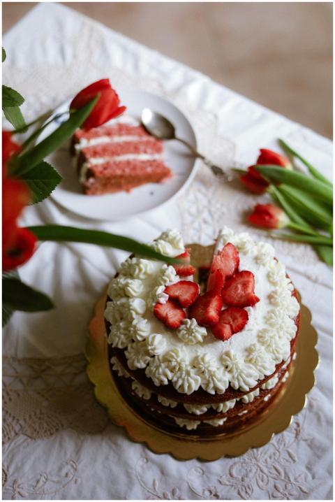 Elegant strawberry cake topped with cream and fres