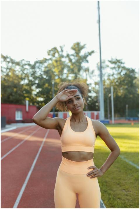 A woman in sports attire taking a break during her