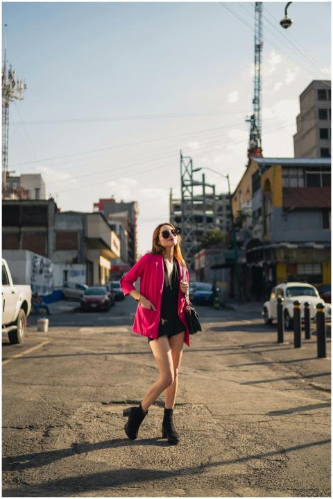 Confident woman in pink jacket struts through live