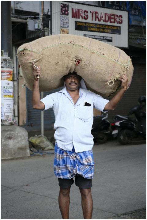 Man Carrying Large Burlap